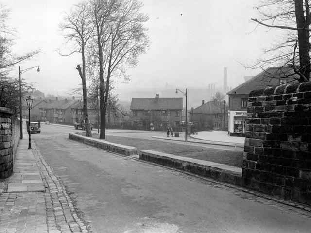 St. Ann's Lane looking towards the junction with Kirkstall Hill and Burley Road, with Burley Wood Lane going off to the right in May 1951. Thrift Stores Ltd., grocers, is just visible on the corner, partially hidden by a stone wall.