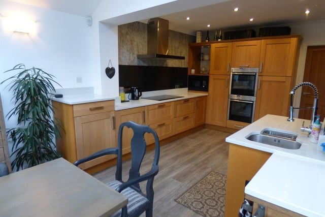 The well equipped dining kitchen has fitted units with integrated appliances.