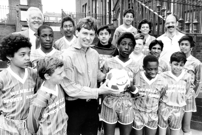 May 1987 and England and Manchester United captain Bryan Robson visited Harehills Middle School where he presented the school football team with a complete strip donated by Wembley Sportsmaster Ltd and a football. He is pictured withteam captain Donovan Daniel.
