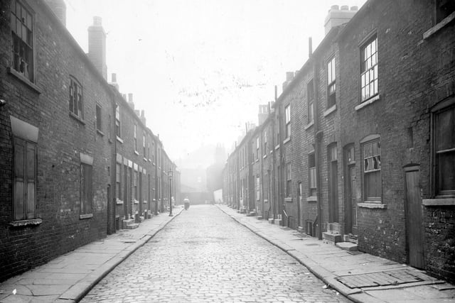 Cannon Street in August 1935. The street was intersected by Regent Street into two halves. Looking down the street, brick property, back-to-back terrace in a state of dereliction, some appear to be still inhabited at the end of the street.
