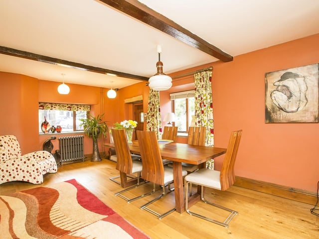 The beamed dining area has doors outside to the gardens.