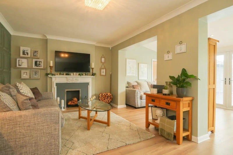 The living room is tastefully decorated with a recessed fire place and opens to the dining room.