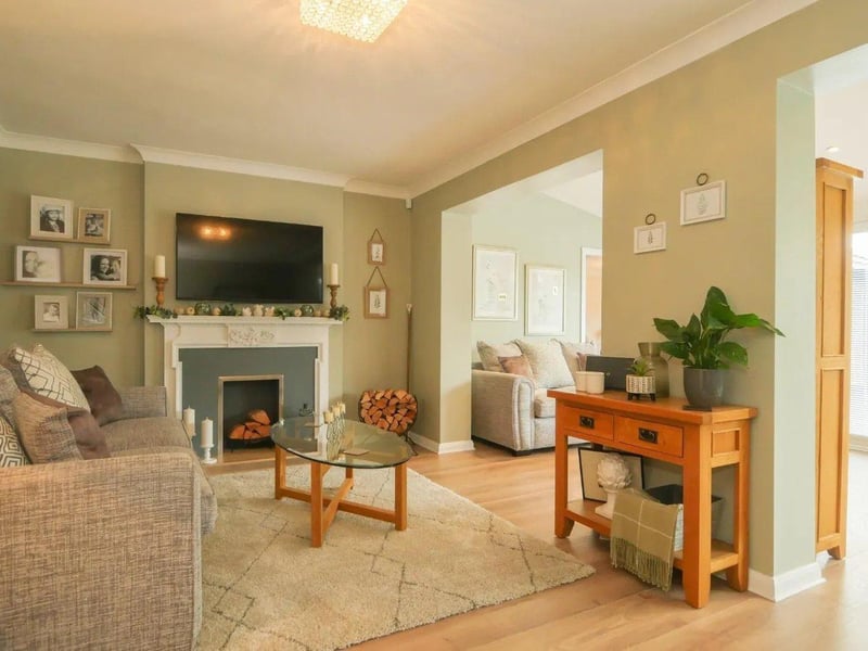The living room is tastefully decorated with a recessed fire place and opens to the dining room.