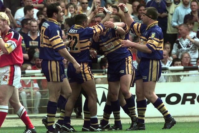Rhinos celebrate after one of Leroy Rivett's four tries.