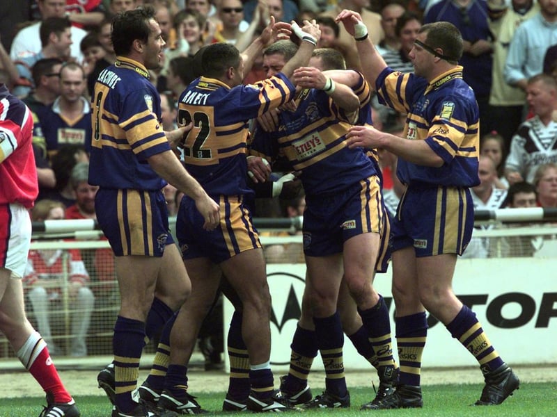 Rhinos celebrate after one of Leroy Rivett's four tries.