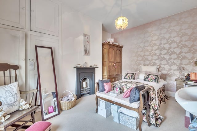 Upstairs to the first floor, there are two large double bedrooms, including the master with built-in period fireplaces and large windows.