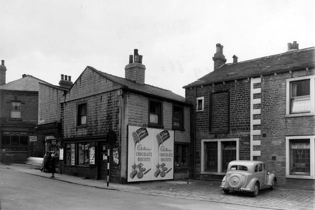 Gibbs and Son newsagents on Town Street in July 1954. Next door is the 'Concert Rooms'. Lloyds Bank Ltd can be seen in the far left of the photo.