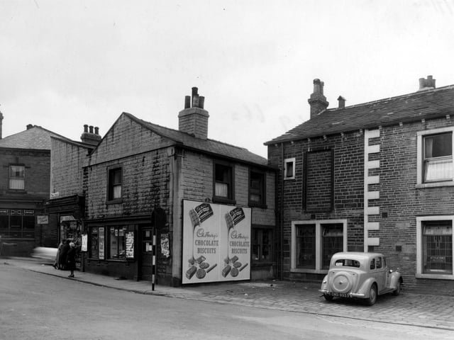 Gibbs and Son newsagents on Town Street in July 1954. Next door is the 'Concert Rooms'. Lloyds Bank Ltd can be seen in the far left of the photo.