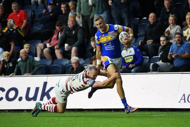 Ash Handley is tackled just short of the line by Wigan's Liam Marshall. Picture by Jonathan Gawthorpe.