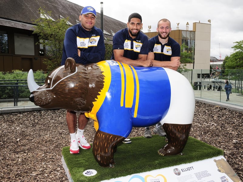Leeds Rhinos players David Fusitu'a, Nene McDonald and Jarred O'Connor with the Leeds Rhino Bear in the SOYO neighbourhood, next to Leeds Playhouse
