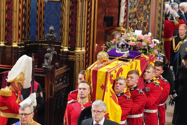 The coffin of Queen Elizabeth II is carried by the Bearer Party into her State Funeral
