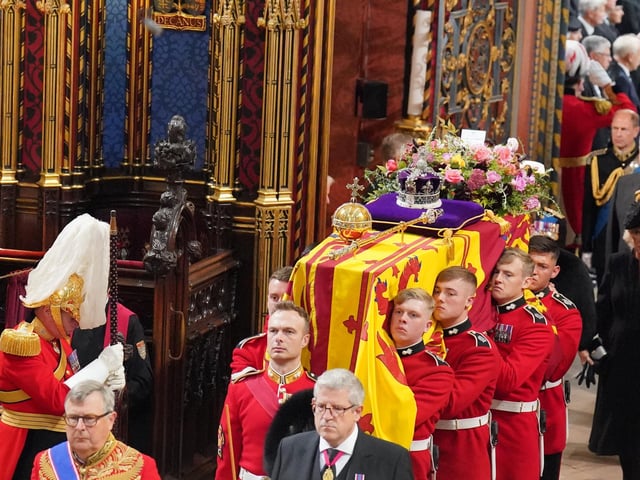 The coffin of Queen Elizabeth II is carried by the Bearer Party into her State Funeral