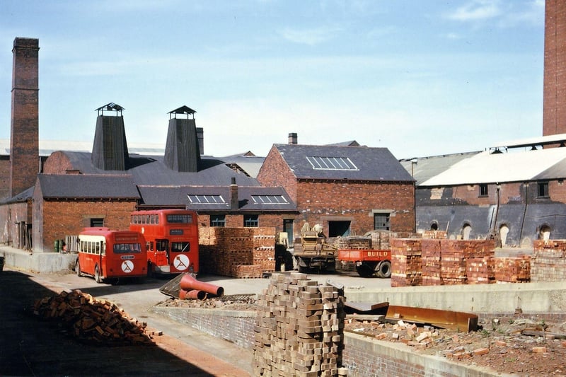 George Armitage & Sons Ltd. Brick Works showing brick kilns. Also seen is a red single decker bus and a red double decker bus, transport for workers at Woodkirk.