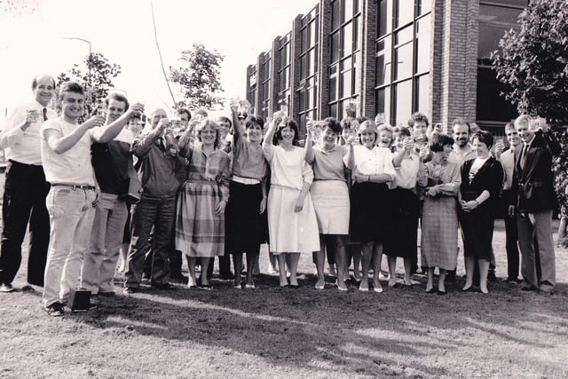Employees of Morley kitchen company Wellmann toast the firm's success in selling kitchens valued at more than £1 million in August 1988. Staff were presented with a commemorative tankard from the managing director John Kinder during a champagne party.