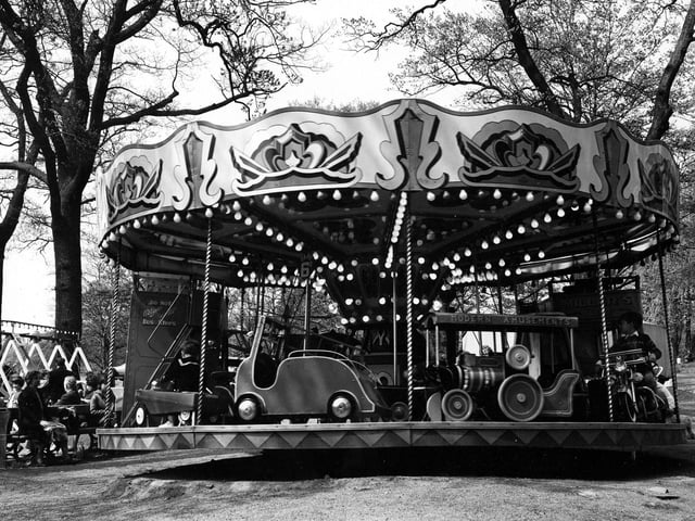 A small childrens carousel located near the Waterloo lake side car park at Roundhay Park. Run by the Miller family the ride consists of scaled down vehicles for children including a fire engine, a train, a motorcycle and two buses with notices reading 'Do Not Alight Until Bus Stops' on the rear and Miller's Tours, on the front. A sign shows the fare to be 6D,. The fairground was removed in the late 1990s.