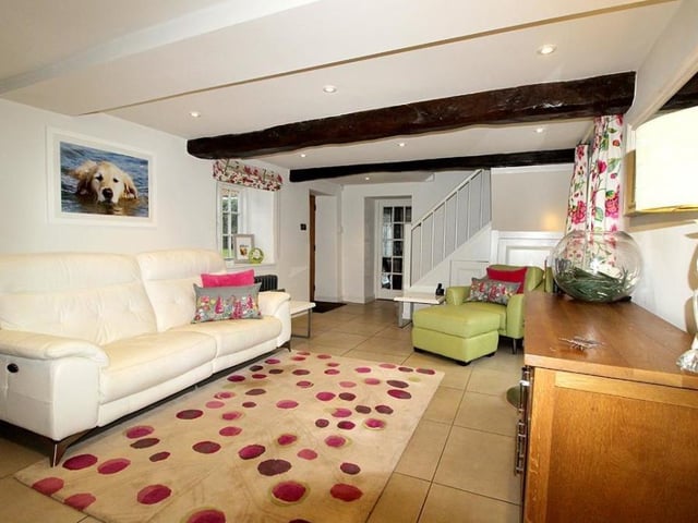This beamed open living area links to the kitchen and diner.