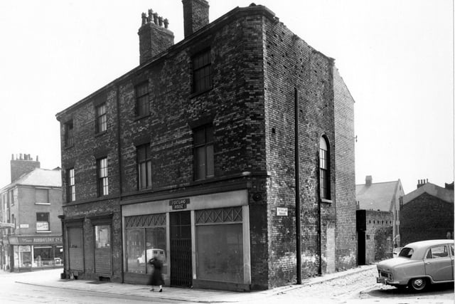 Woodhouse Lane (Portland House) with the empty No.77 on the left. The properties are between Portland Crescent and Back Portland Crescent, where a car is parked. Further along is No.75, Rubbaflors Ltd.