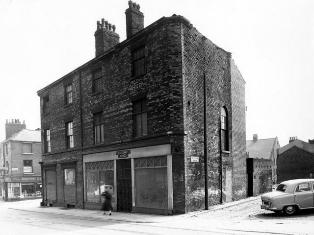 Woodhouse Lane (Portland House) with the empty No.77 on the left. The properties are between Portland Crescent and Back Portland Crescent, where a car is parked. Further along is No.75, Rubbaflors Ltd.