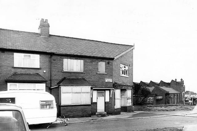 A boarded up premises on South End Grove in  May 1979. On the left a caravan is parked while on the right can be seen the J & C.Croysdale Ltd building.