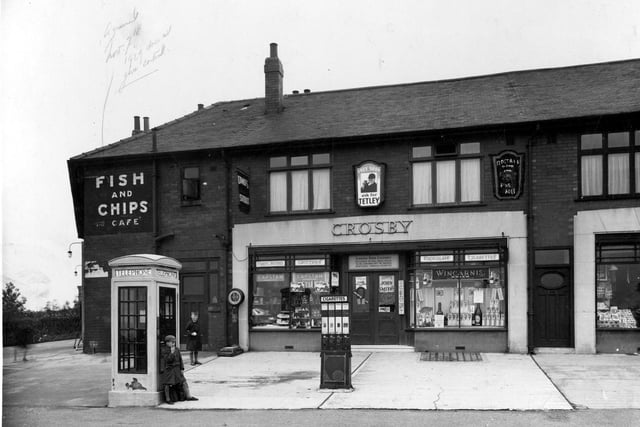 Potternewton Lane pictured in July 1936 showing the grocery business of Sarah Ann Crosby. Cigarette machine and weighing machine can be seen outside. Around the corner is Fred Dawson's Fish & Chip shop.