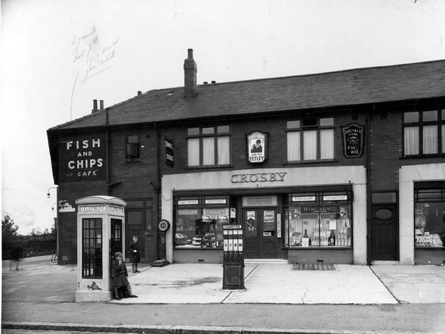 Potternewton Lane pictured in July 1936 showing the grocery business of Sarah Ann Crosby. Cigarette machine and weighing machine can be seen outside. Around the corner is Fred Dawson's Fish & Chip shop.