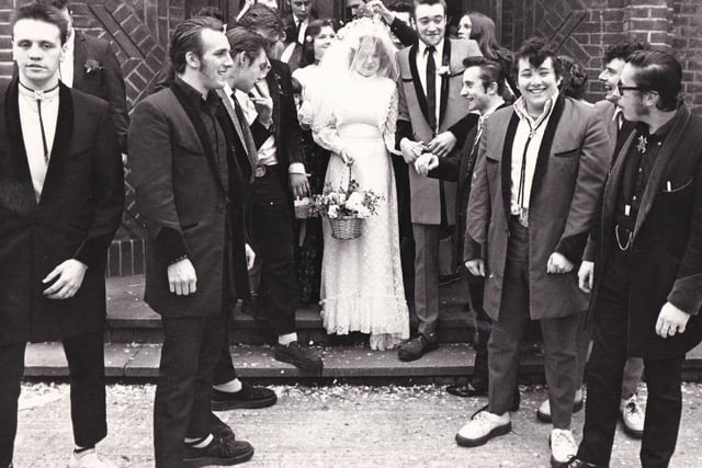 Drape jackets, crepe-soled shopes and a tradtional bride at a wedding in Bramley in March 1977.