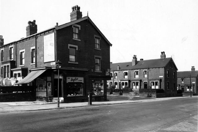 Ingle's fruit and flowers and number 360, Craven's tobacconists on Harehills Lane, between Brownhill and Sutherland Terraces. Sutherland Mount visible. Streetlamp, postbox and advertisements for "Wisk", Lyon's chocolate and Gold Flake tobacco visible. Pictured in September 1949.