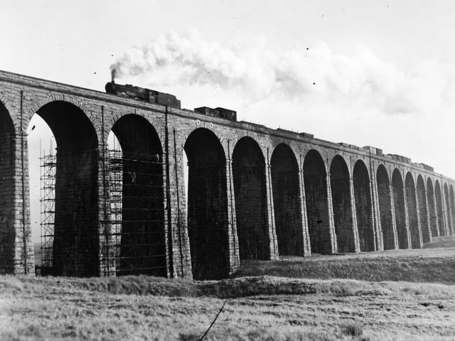 A steam train passes over Ribblehead Viaduct in January 1960.