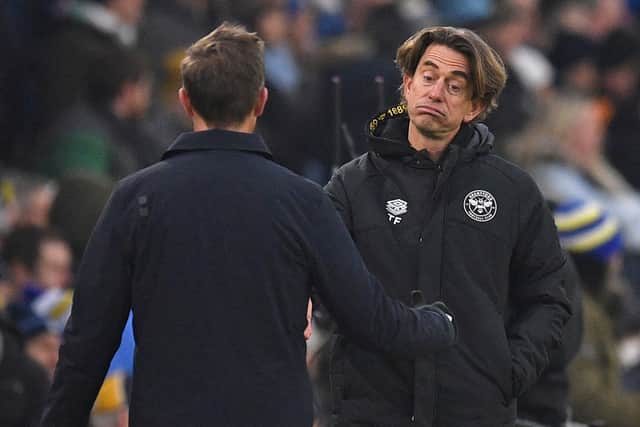 Brentford's Danish head coach Thomas Frank (R) reacts as he walks towards Leeds United's US head coach Jesse Marsch (L) on the final whistle. (Photo by OLI SCARFF/AFP via Getty Images)
