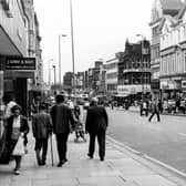 Briggate thronged with people in April 1979. On the left is J.Weir & Son 'the jeweller's who care' and further down, Debenhams. On the right, Dolcies shoe shop is visible on the corner with Albion Place, then Hornes and Hepworths followed by the Army Stores and Peter Lord's far right.