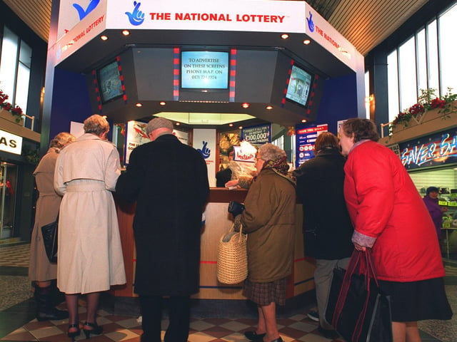 Punters queue up to enter the National Lottery at the kiosk in the Crossgates Shopping Centre in January 1996.