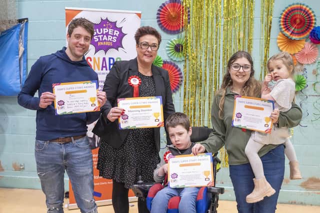 SNAPS Super Star Phoenix receiving his certificate at last year's Super Stars awards, with his family