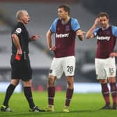 Tomas Soucek appeals to match referee Mike Dean after being shown a red card during the Premier League match between Fulham and West Ham United at Craven Cottage on 6 February 2021. (Pic: Getty Images)