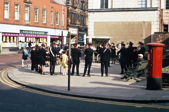 The Morley Salvation Army Band taking part in a Sunday evening service in the open space in front of Windsor House in June 1970. Two years later this space was being built on, with the shops at the bottom of Windsor Court Shopping Precinct and Windsor House being demolished. The co- operative supermarket on the other side of Queen Street did not long survive the opening of Morrison's Supermarket at the top of the precinct, with its vast amount of nearby free parking.