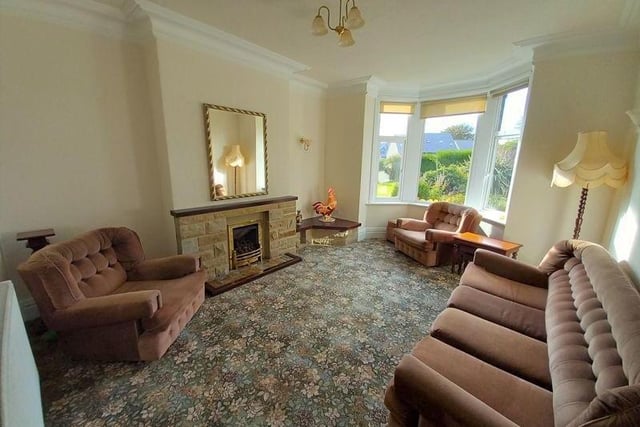 The sizeable lounge within the property has a bay window and central fireplace.