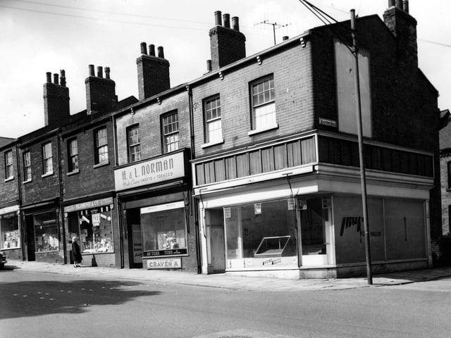 A parade of shops on Beeston Road taken opposite the junction with Malvern Road. Numbers are descending order from the left. Number 80 is Christine, ladies hairdresser, number 78 is Rose Plow's ladies outfitters and dry cleaners, 76 is Richmond & Co Wallpaper stores and H. L. Norman High Class Sweets and Tobacco is at number 74. The food store on the corner appears to be empty.