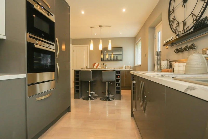 The kitchen/diner has high gloss wall and base units, a central island and an excellent range of integrated appliances.