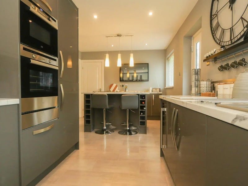 The kitchen/diner has high gloss wall and base units, a central island and an excellent range of integrated appliances.