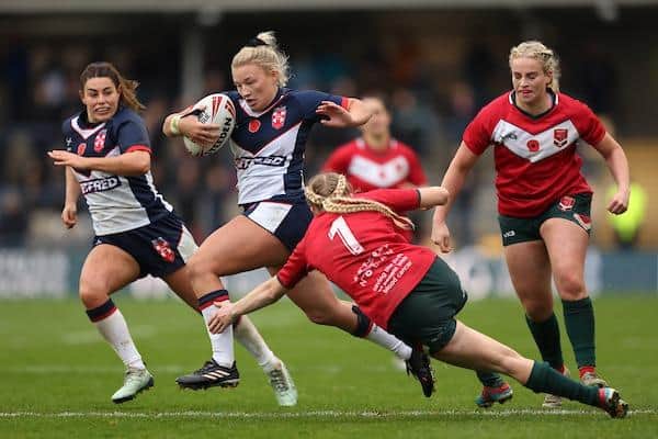 England's former Leeds and Castleford star Georgia Roche takes on Wales' Leanne Burnell. Picture by John Clifton/SWpix.com.