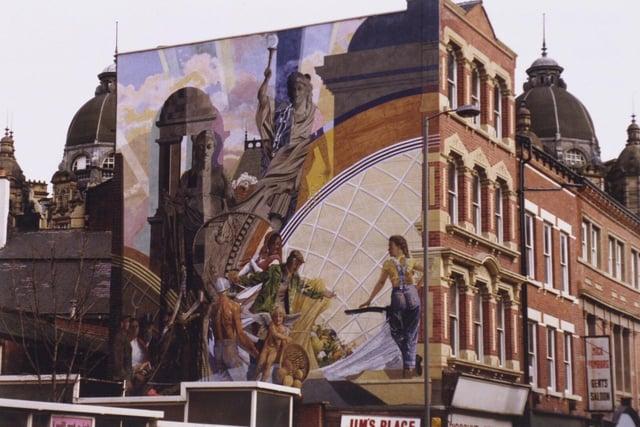 This is Cornucopia, a landmark fresco by artist Graeme Willson and on public display near the Corn Exchange in the city centre. It was painted in 1990.