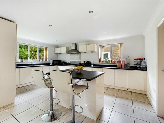 The kitchen is equipped with modern appliances, ample storage space, and a stylish island that doubles as a breakfast bar.