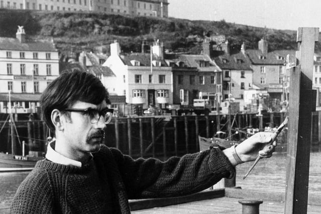 Artist John Freeman painting Whitby Harbour in March 1971.