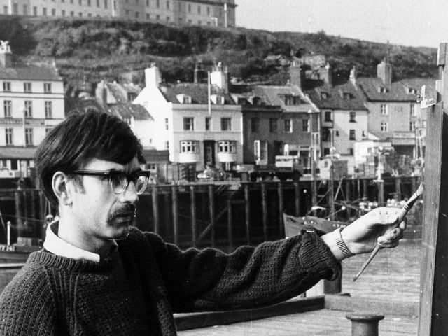 Artist John Freeman painting Whitby Harbour in March 1971.