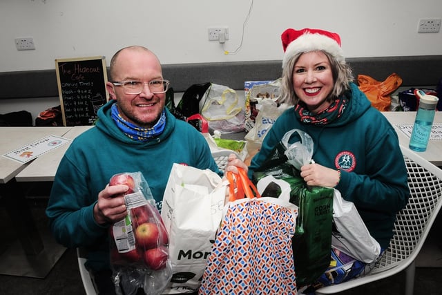 Dynamos chairman Danny Barnes and volunteer Katie Weldon with some of the donations for the food bank