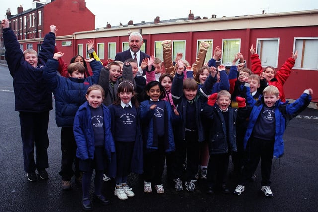 Mount Saint Mary's Primary headteacher Martin Flannery with Year 1,2 and 4 pupils  in the school playground in December 1999. They were celebrating after having been awarded £40,000 to rebuild the school.
