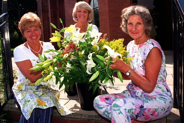 Lynn Barghout, Sue Holroyd and Sheila Quin arrange a display for the Burley in Wharfedale Flower Festival in August 1997.