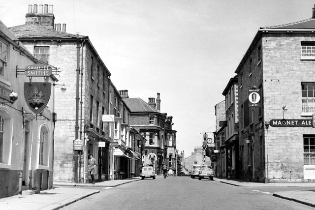 A view of the High Street showing the Crown Public House on the left at number 25, on the corner with Cross Street. Opposite, at the junction with Victoria Street, is the Brunswick at number 22, previously the Devonshire. Pictured in May 1963.