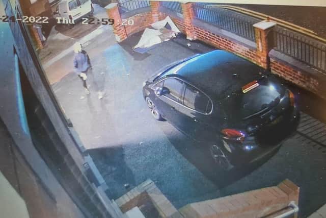 CCTV footage shows the hooded figure approach the car and throw paint on it at 11pm on Thursday, November 24
