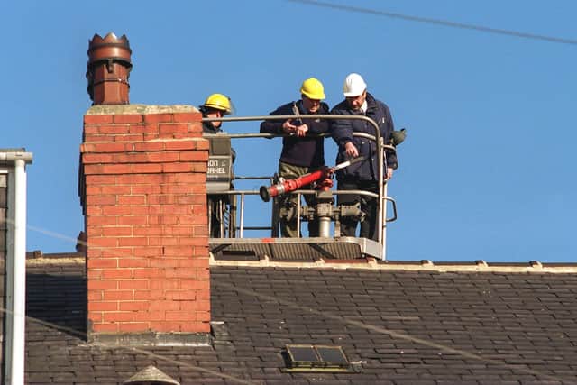 Police examine the roof of the house in Austhorpe Road, Cross Gates, following the murder. Picture: Dan Oxtoby