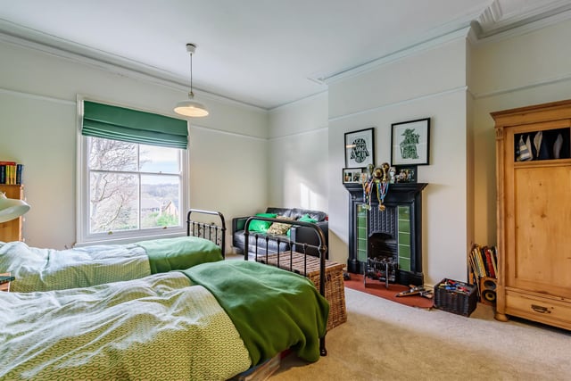 There are five bedrooms in the family home, including this one with original features.